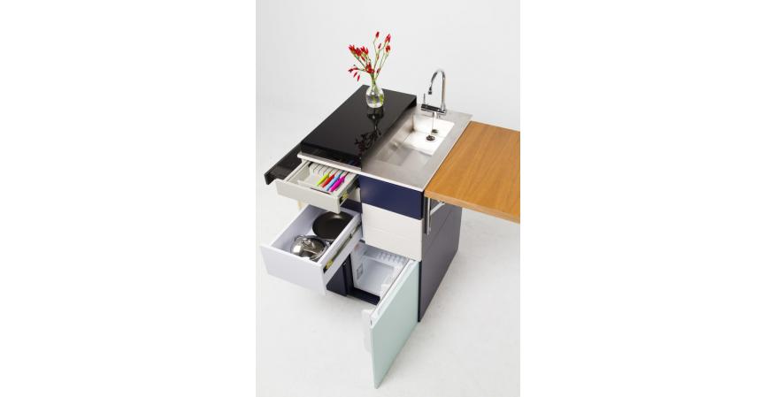 Ana Arana has developed a new compact and transportable kitchen module that includes everything someone living in a small space would need, including sink, fridge, induction cooktop, storage, and dining table.
