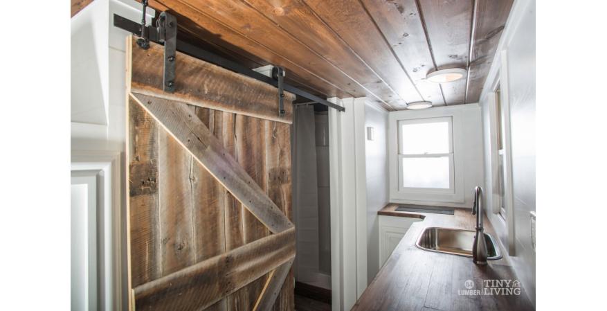It has a reclaimed wood accent wall and custom-designed barn door.