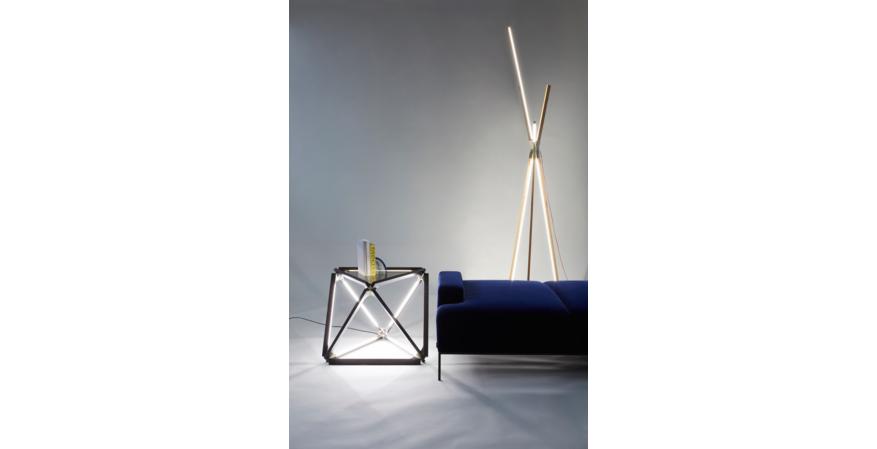 An X Light table, made with 2-foot Stickbulbs and a bronzed-glass top, alongside a 9-foot-tall Big Bang floor lamp.