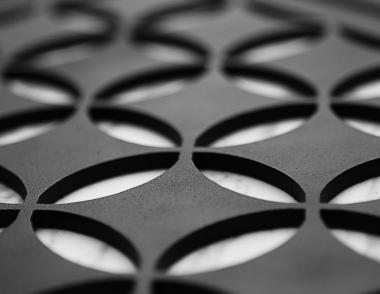 A black grille from AJK Design Studio with a Moroccan pattern for AC registers.