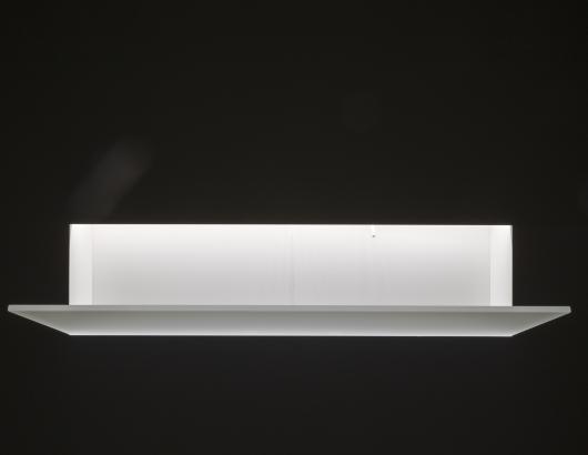 Corian sink that is inserted into the wall cavity and is visible only by a sheet of glass that protrudes from the surface.