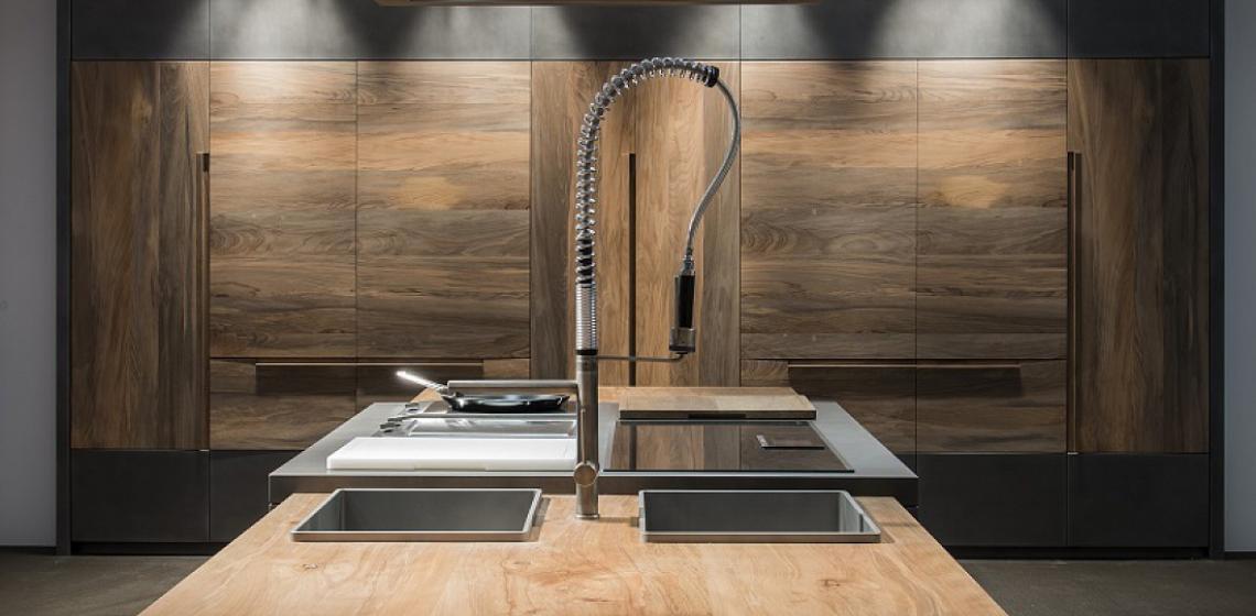 Seeking a stand-out material for its new line of products, Italian cabinet brand Toncelli turned to an 800-year-old Serbian beechwood whose well-seasoned personality will resist water absorption and abrasion, the company says.  The wood is being used for the company's Essence line. While the fossil beechwood makes up the majority of the kitchen, titanium steel is used for the cooking surface.