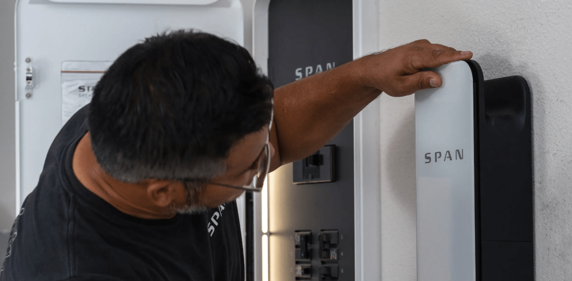 Man installing Span panel in home